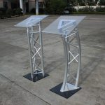 podium stand, podium, lectern, presentation podium, presentation stand, speaker podium, speaker stand, conference podium, conference stand, meeting podium, meeting stand, office podium, office presentation stand, executive podium, executive lectern, professional podium, professional lectern, modern podium, modern lectern, wooden podium, wooden lectern, metallic podium, metal podium, steel podium, aluminum podium, acrylic podium, glass podium, portable podium, mobile podium, adjustable podium, height adjustable podium, standing podium, floor podium, church podium, church lectern, pulpit podium, pulpit stand, preaching podium, preaching lectern, school podium, classroom podium, teacher podium, lecturer podium, university podium, college podium, training podium, seminar podium, workshop podium, conference lectern, boardroom podium, corporate podium, corporate lectern, business podium, meeting room podium, reception podium, event podium, event lectern, wedding podium, ceremony podium, graduation podium, public speaking podium, speech podium, speaker lectern, microphone podium, podium with microphone stand, podium with shelf, podium with storage, podium with reading surface, podium with document holder, podium desk, presentation desk, presentation table stand, display podium, display stand, exhibition podium, promotional podium, information podium,