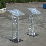 podium stand, podium, lectern, presentation podium, presentation stand, speaker podium, speaker stand, conference podium, conference stand, meeting podium, meeting stand, office podium, office presentation stand, executive podium, executive lectern, professional podium, professional lectern, modern podium, modern lectern, wooden podium, wooden lectern, metallic podium, metal podium, steel podium, aluminum podium, acrylic podium, glass podium, portable podium, mobile podium, adjustable podium, height adjustable podium, standing podium, floor podium, church podium, church lectern, pulpit podium, pulpit stand, preaching podium, preaching lectern, school podium, classroom podium, teacher podium, lecturer podium, university podium, college podium, training podium, seminar podium, workshop podium, conference lectern, boardroom podium, corporate podium, corporate lectern, business podium, meeting room podium, reception podium, event podium, event lectern, wedding podium, ceremony podium, graduation podium, public speaking podium, speech podium, speaker lectern, microphone podium, podium with microphone stand, podium with shelf, podium with storage, podium with reading surface, podium with document holder, podium desk, presentation desk, presentation table stand, display podium, display stand, exhibition podium, promotional podium, information podium,